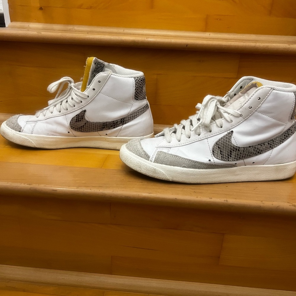 Nike blazers with a grey/black snakeskin swoosh and on top behind the shoes.